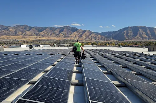 Solar technician servicing rooftop solar panels